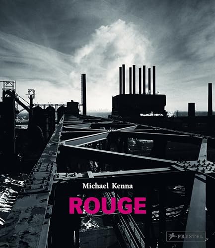 Black and white industrial landscape with smokestacks and dramatic sky.