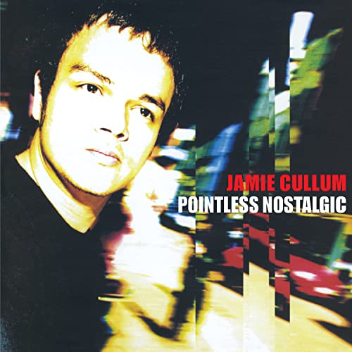 Jamie Cullum album cover, portrait with blurred city lights background.