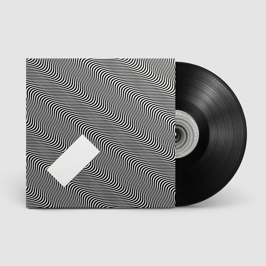 Vinyl record with Jamie xx album In Waves cover art on sleeve packaging.