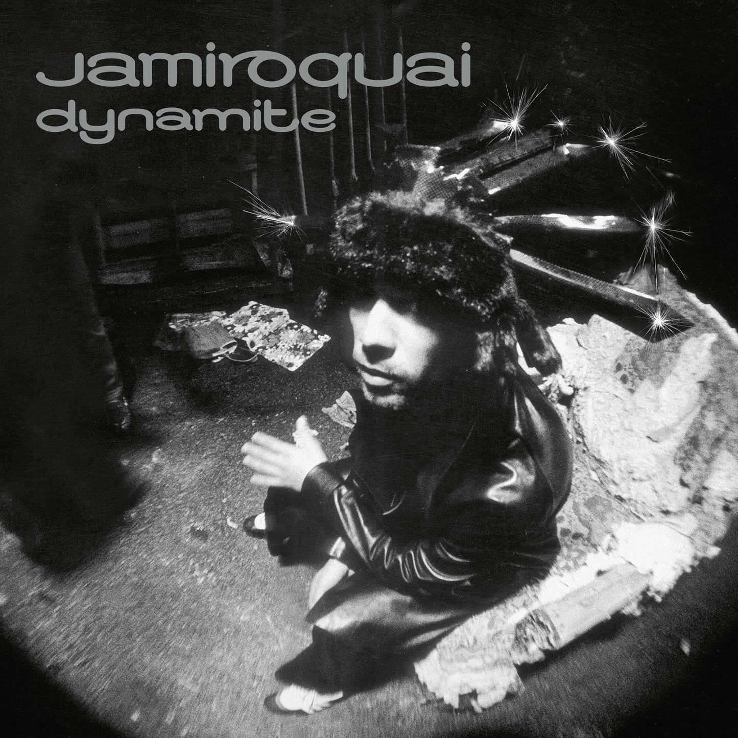 Black and white album cover featuring Jay Kay wearing a fur hat with sparkles.