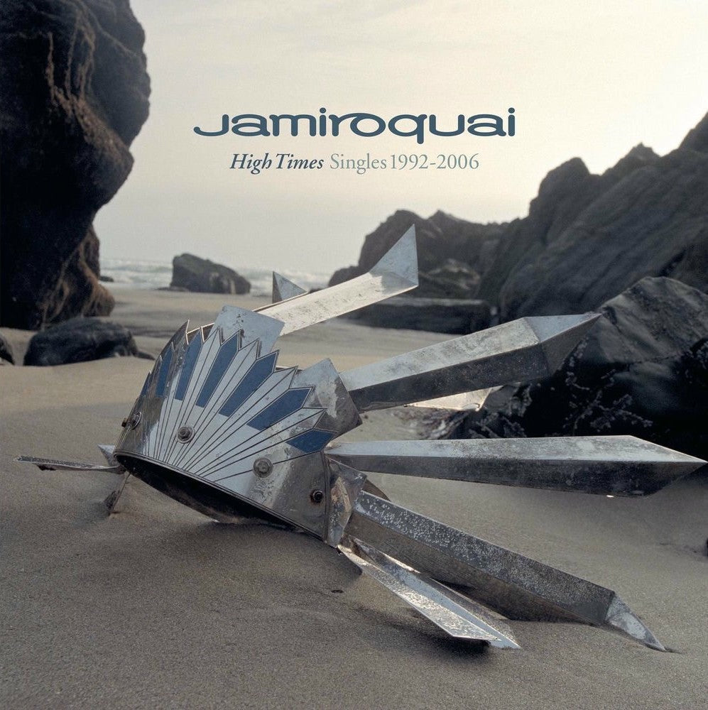 Jamiroquai “High Times” album cover featuring a metallic fish sculpture on a beach.