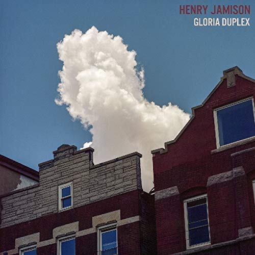 "Album cover featuring a red brick building with a large white cloud."