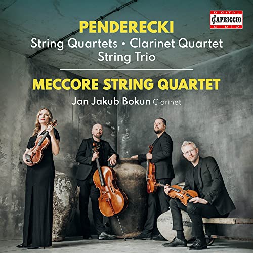 Classical musicians with string instruments pose in front of a textured wall.