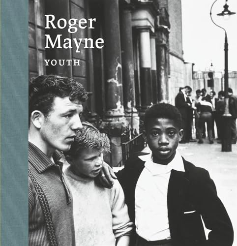 Black and white photo of three young men on a city street.
