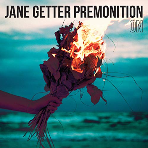 Album cover: burning bouquet held against a blurred ocean backdrop.