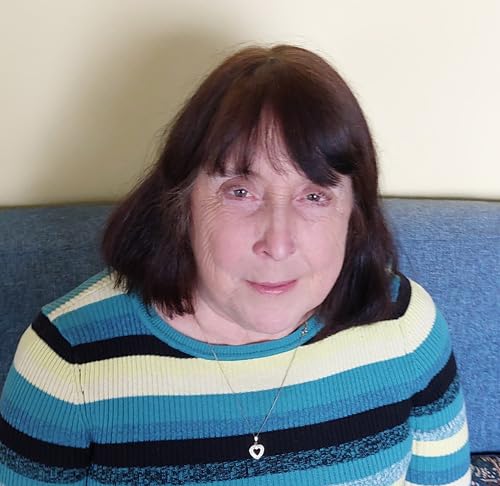 Woman with dark hair and a striped sweater, looking at the camera.