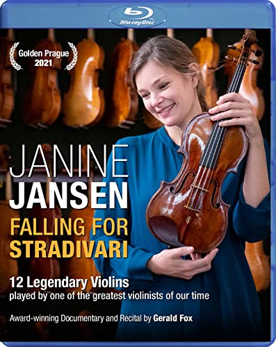 Janine Jansen holding a violin, with other violins in the background.