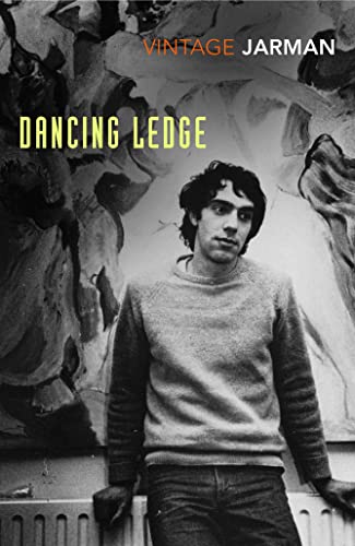 Black and white book cover featuring a man in a sweater against abstract art.