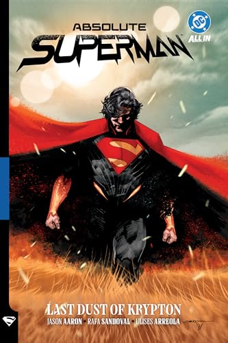 Superman in a black suit and red cape walks through a field of dust.