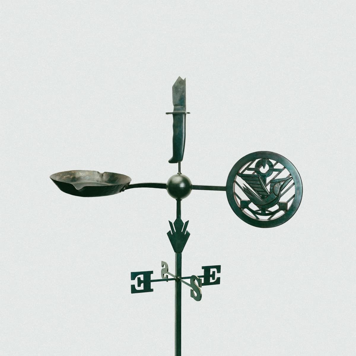 "Green metal weathervane with bird design, bowl, and directional letters on a plain background."