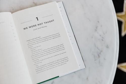 Open book titled “Talk Money to Me” resting on a marble surface.