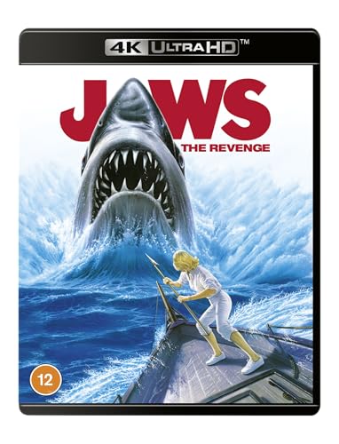 A shark rises from the water behind a woman holding a spear on a boat.