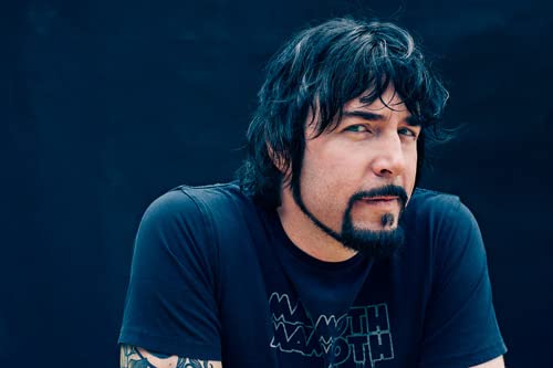 Portrait of Jay Kristoff, author with dark hair and beard.