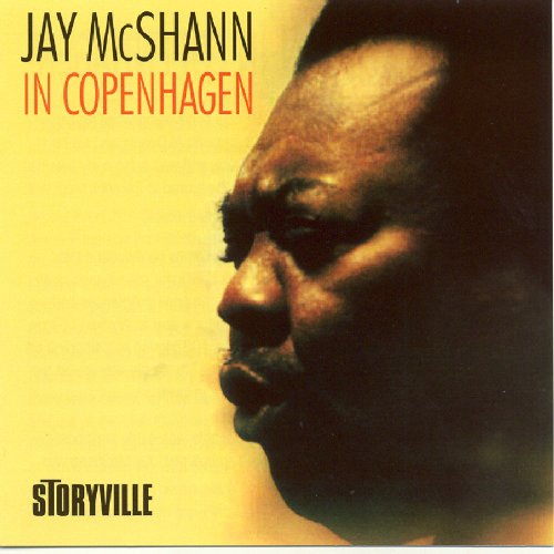 "Album cover with a man's profile on a yellow background, titled 'Jay McShann in Copenhagen'."