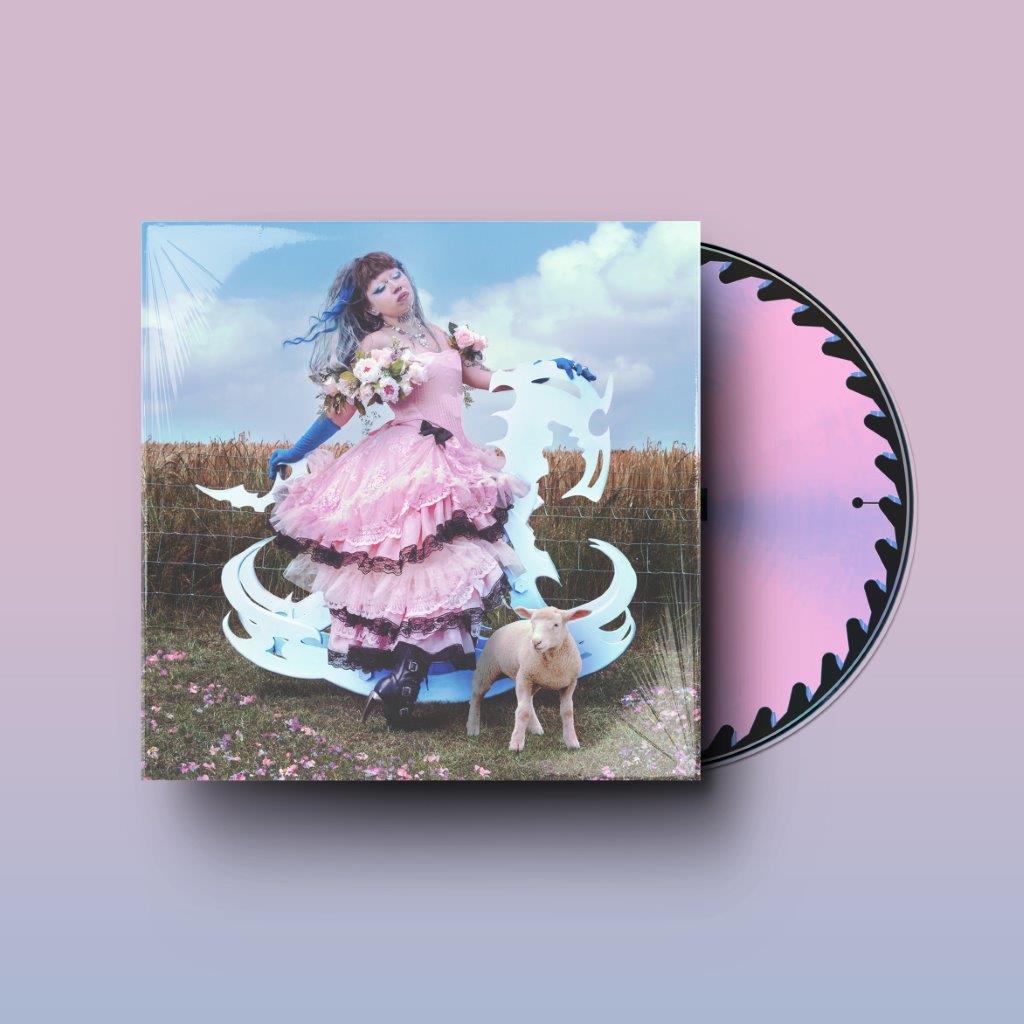 CD cover featuring a woman in pink with a lamb and cloudy sky.