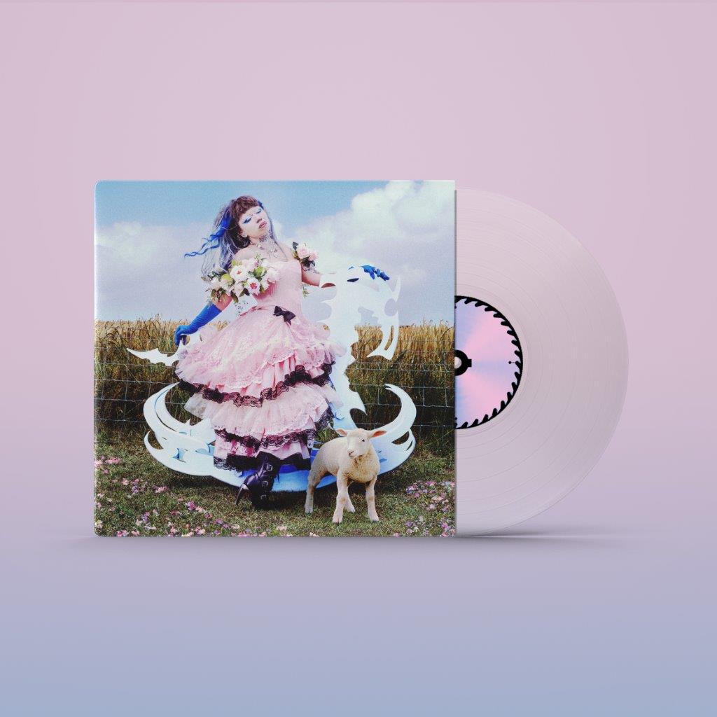 Vinyl record with cover art of a person in a pink dress and a goat.