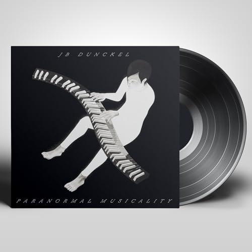 Vinyl record and album cover featuring a silhouetted figure with a piano.