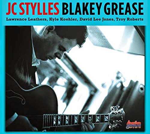 "Album cover with man playing guitar, turquoise border, and artist names listed."