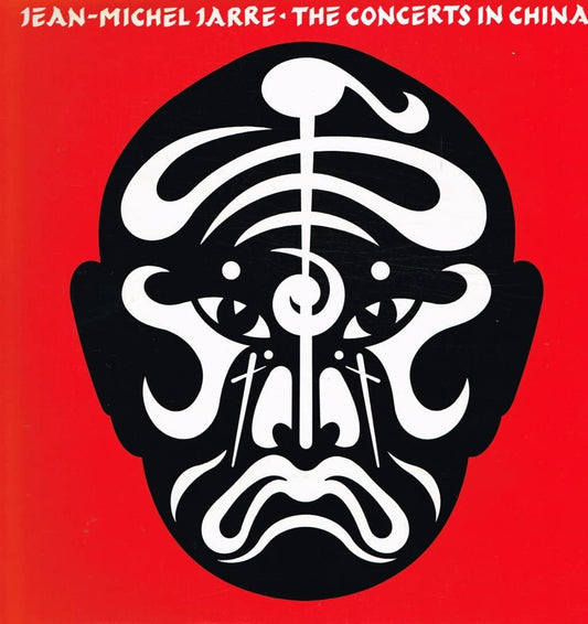 Red album cover with black and white face design and white text at top.