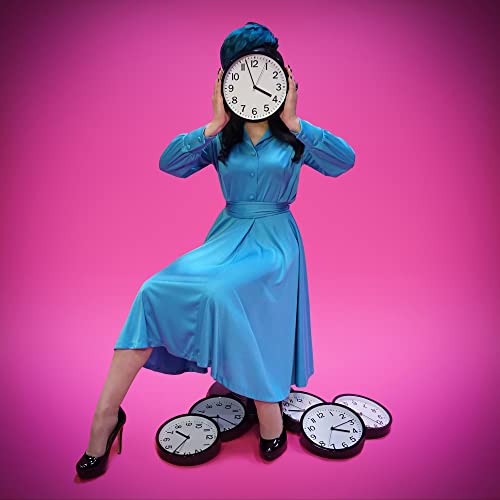 Woman in blue dress with a clock obscuring her face, pink background.