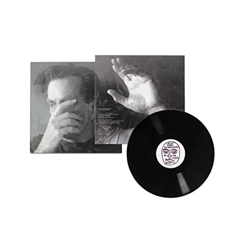 Black vinyl record with album cover featuring a man covering his face.