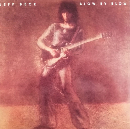 Jeff Beck playing guitar on the album cover “Blow By Blow”.
