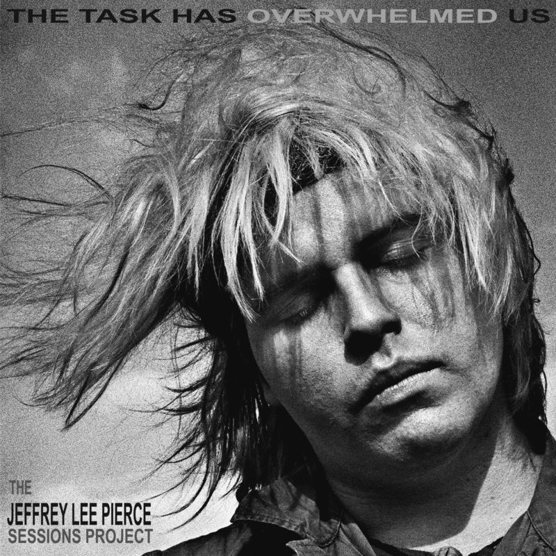 Black and white portrait of a man with long, messy hair.