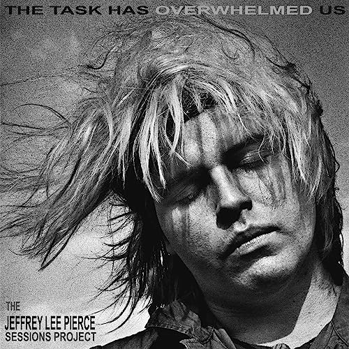 Black and white portrait of a man with long hair, album cover art.