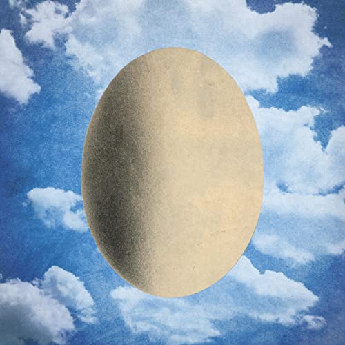 Tan oval shape against a blue, cloudy sky background.