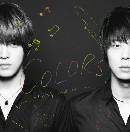 Two men in black shirts against a dark background with colorful hand-drawn doodles.