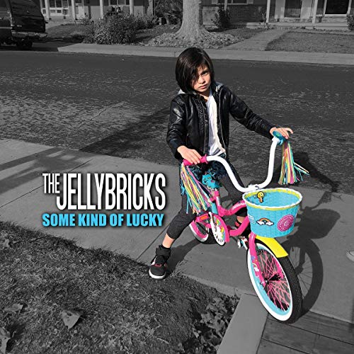 "Album cover with a child on a colorful bike on a suburban street."