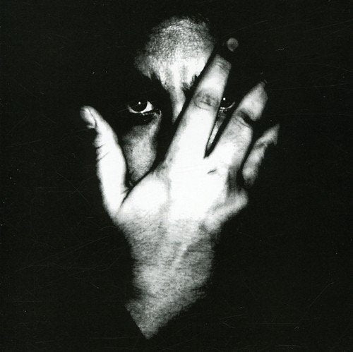 Black and white portrait of a person partially obscuring their face.