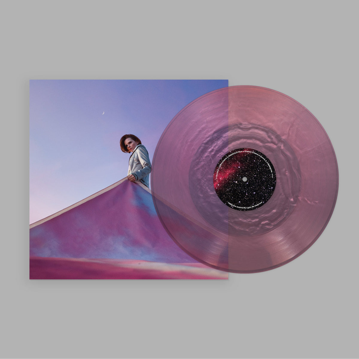 Vinyl record with pink swirl pattern, overlaid on album cover with a woman.