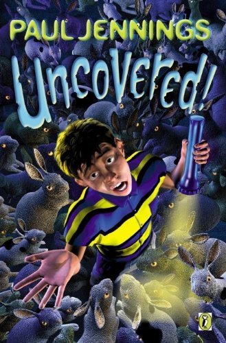 Boy with flashlight surrounded by numerous grey rabbits, book cover.
