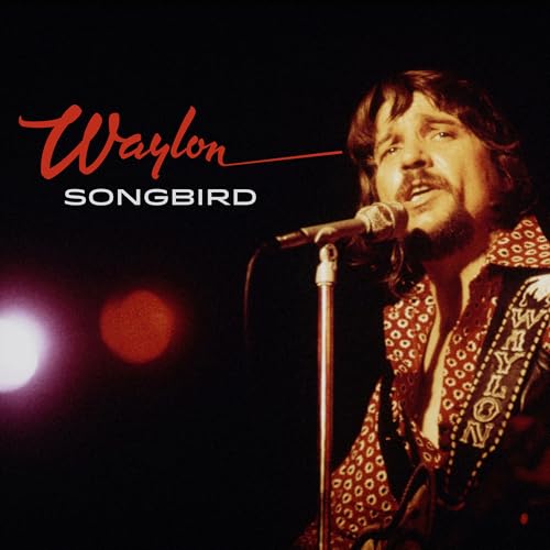 Waylon Jennings singing into a microphone on album cover.