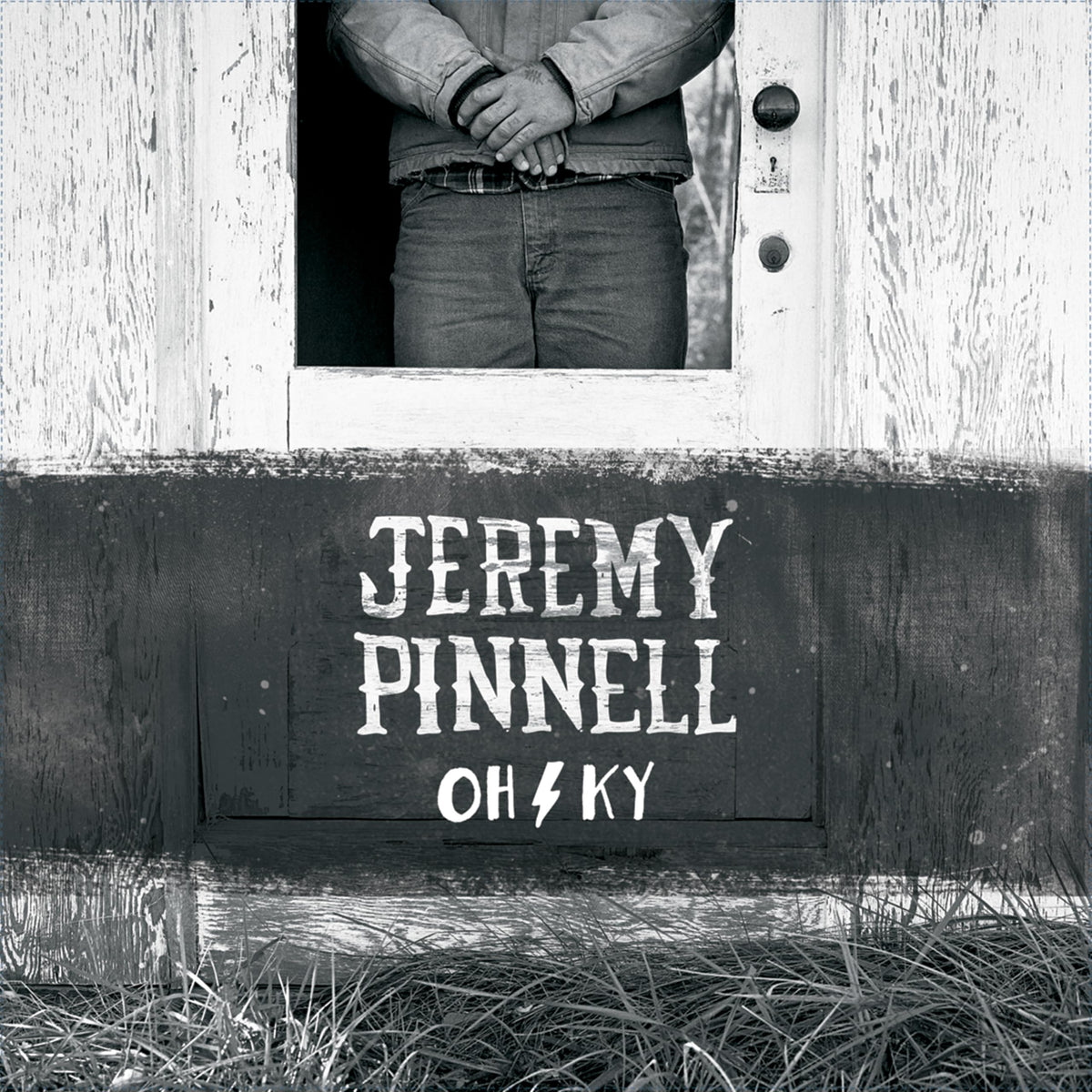 Black and white album cover featuring a man in a doorway and text.