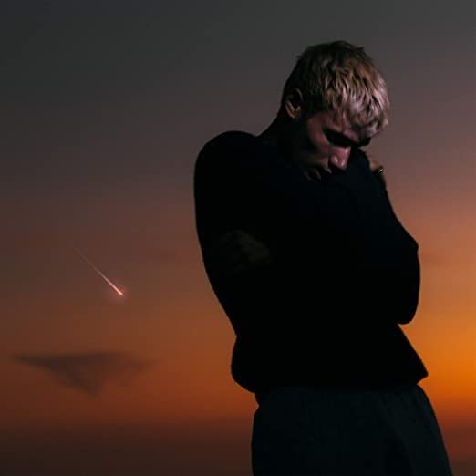 Jeremy Zucker album cover with a man and orange, hazy sky.