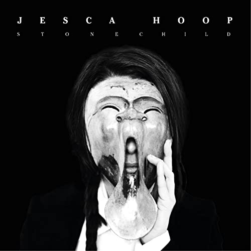 Black and white album cover featuring a person with a mask.