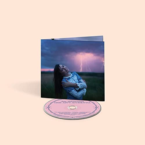CD and cover art featuring a woman lying in grass under a stormy sky.
