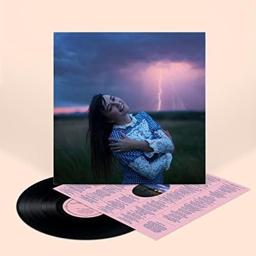 Vinyl record with cover art of a woman under a stormy sky.