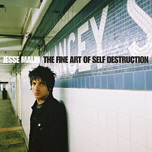Jesse Malin stands in a subway station against a tiled wall with text overlay.