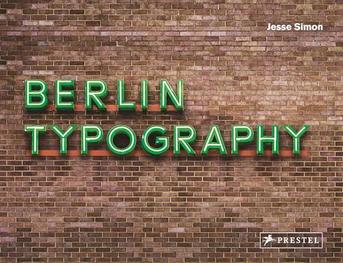 Green neon sign reading BERLIN TYPOGRAPHY on a brown brick wall.