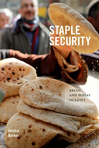 Book cover with stacked flatbreads and a blurred man in the background.