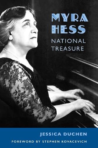 Black and white portrait of pianist Myra Hess at a piano.