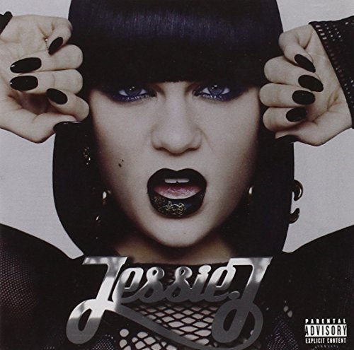 Close-up portrait of Jessie J with dark lipstick and nails, wearing a black hood.
