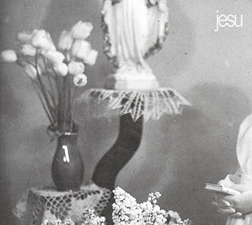 Black and white CD cover with flowers, a lamp, and blurred figures.