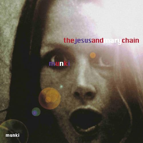 Close-up of a face with colorful orbs, album cover for Munki.