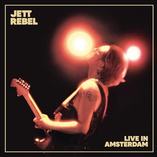 Jett Rebel album cover: musician playing guitar onstage, warm lighting.