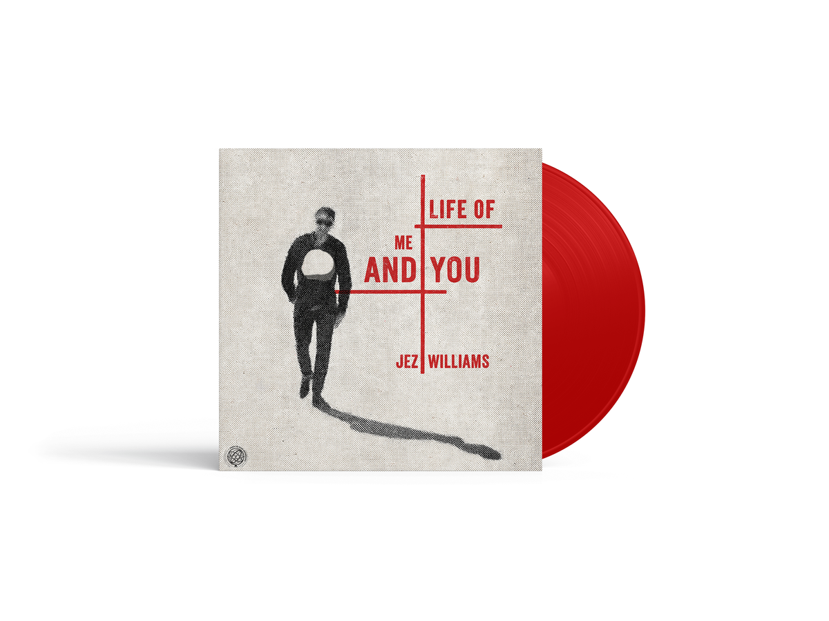Vinyl record with cover art of a silhouetted figure and red disc.