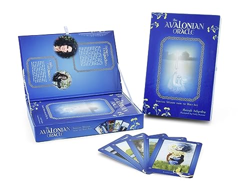 Blue oracle card deck with box, guidebook, and several spread-out illustrated cards.